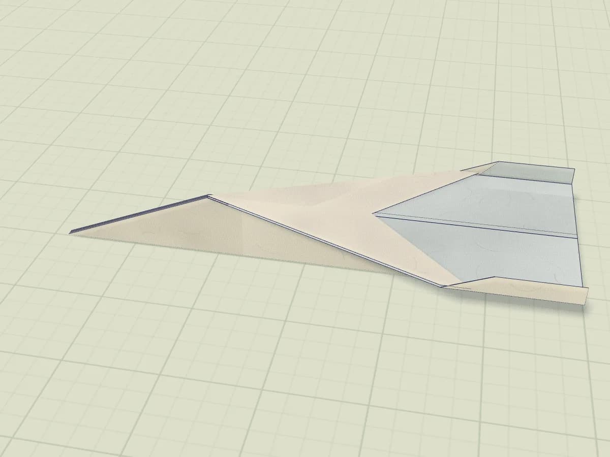 Avion libellule en papier aux grandes ailes et aux petits rebords relevés.