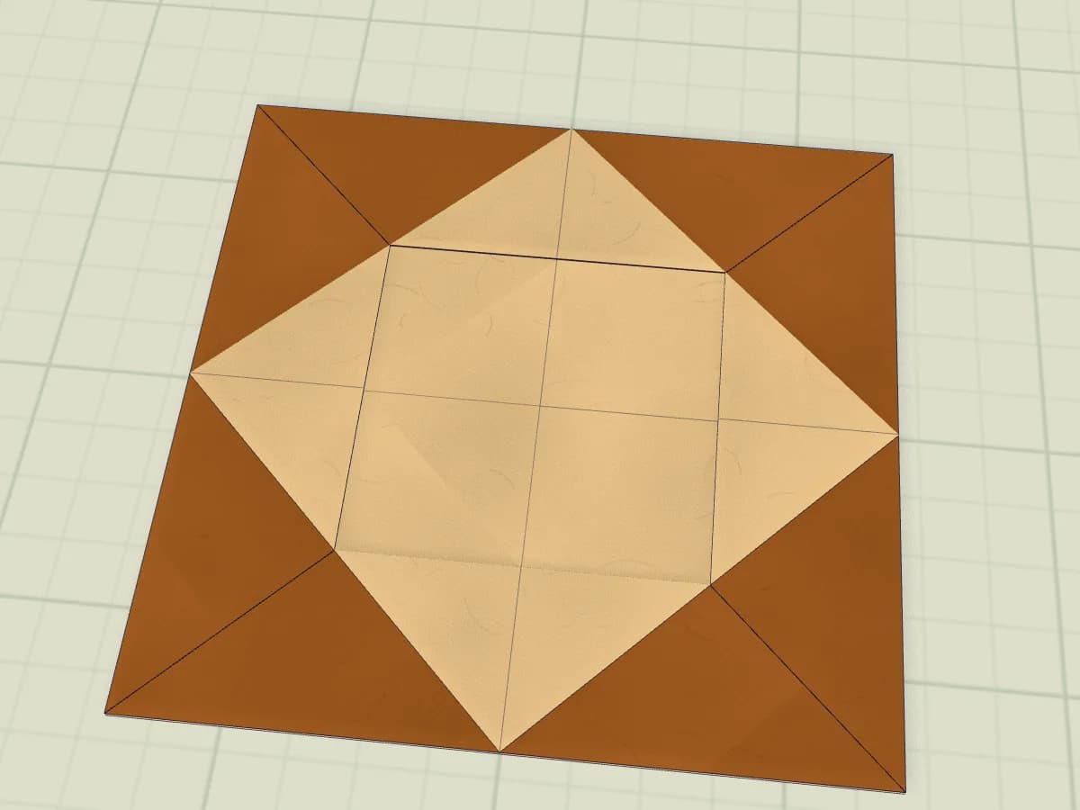 Modèle en papier plié représentant un cadre pour une photo.