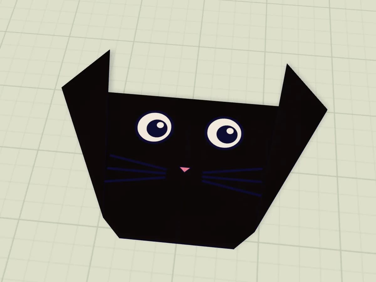 Chat noir en papier avec oreilles triangulaires et menton aplati.