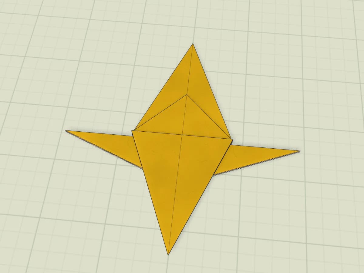 Étoile de Noël en papier plié, avec ses pointes déployées à plat.