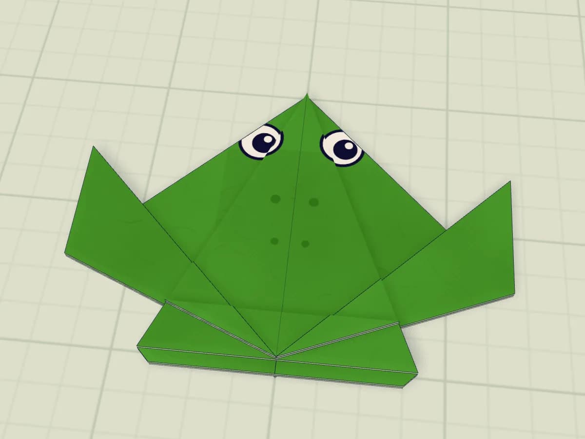Modèle fini de grenouille sauteuse réalisé en papier plié.