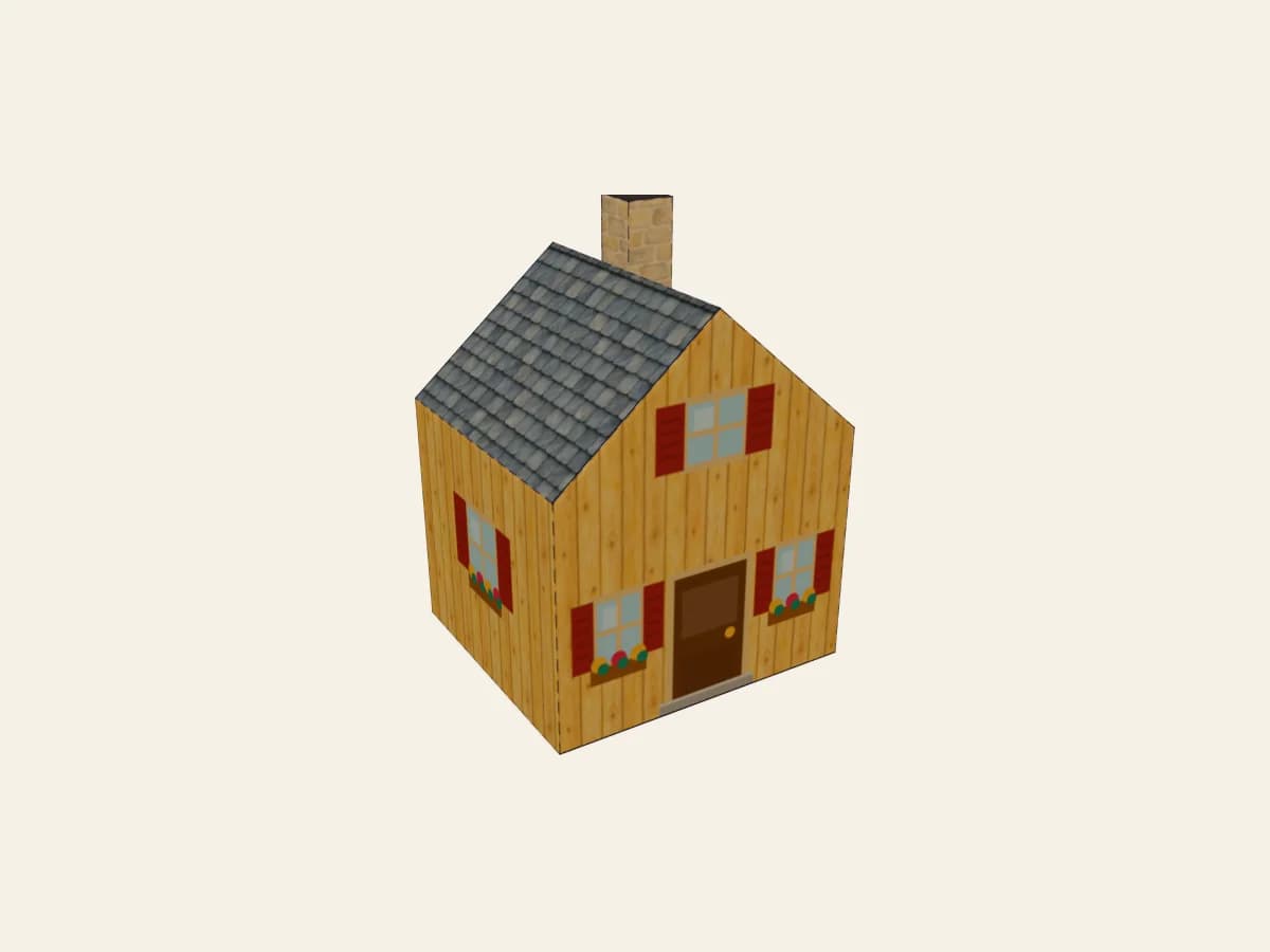 Chalet en papier assemblé, avec sa cheminée et son décor imprimé.