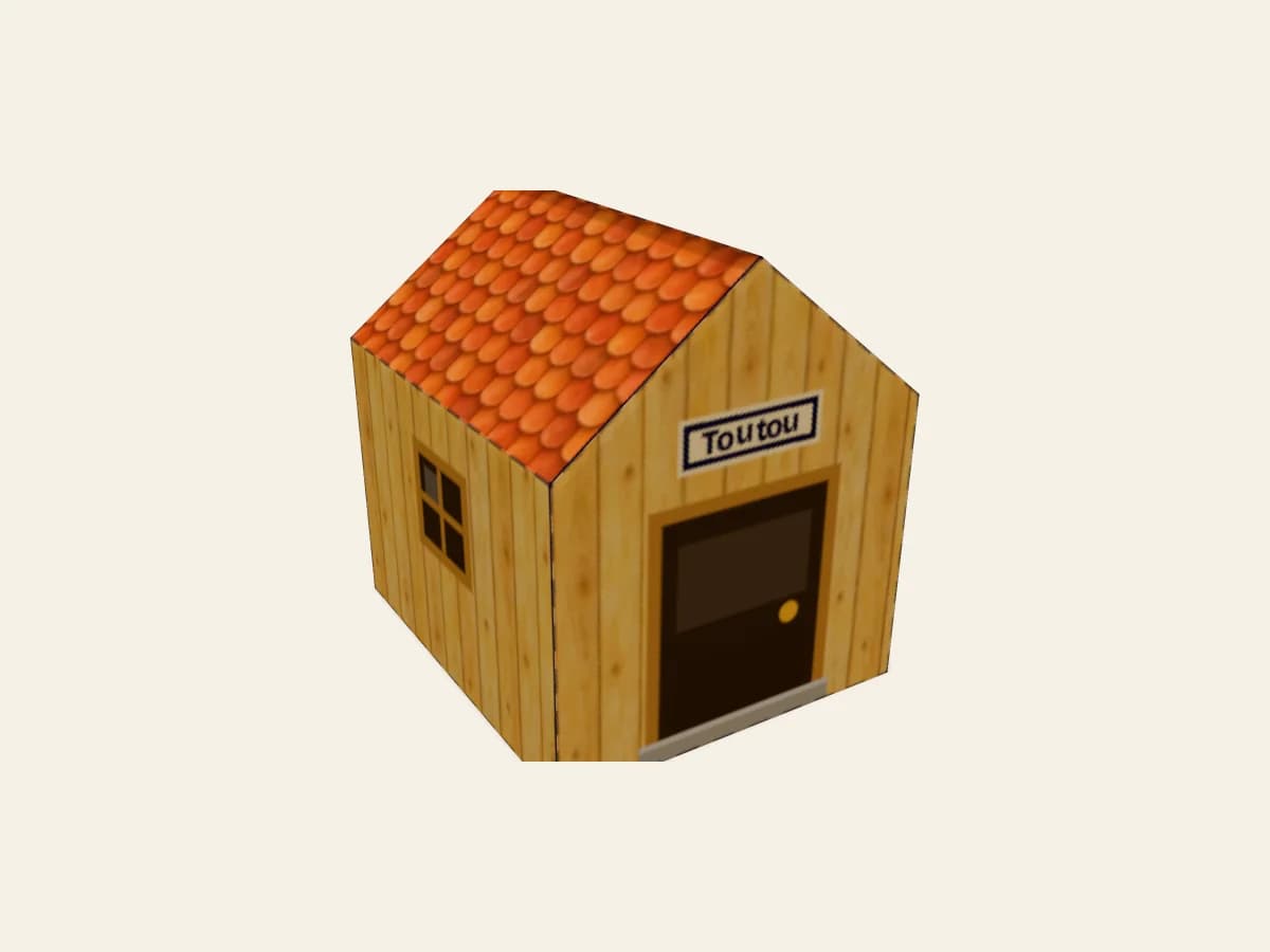 Petite niche de chien en papier avec l’inscription Toutou sur le décor