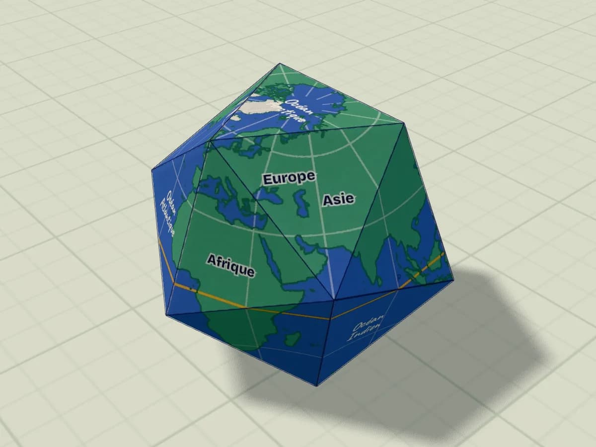 Icosaèdre en papier décoré en globe terrestre, posé sur une face.