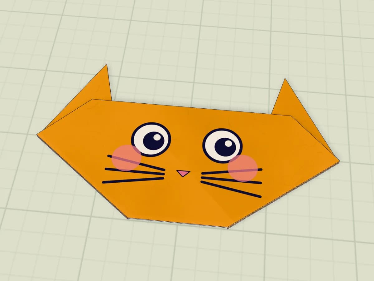 Tête de chat en papier avec oreilles et visage dessiné