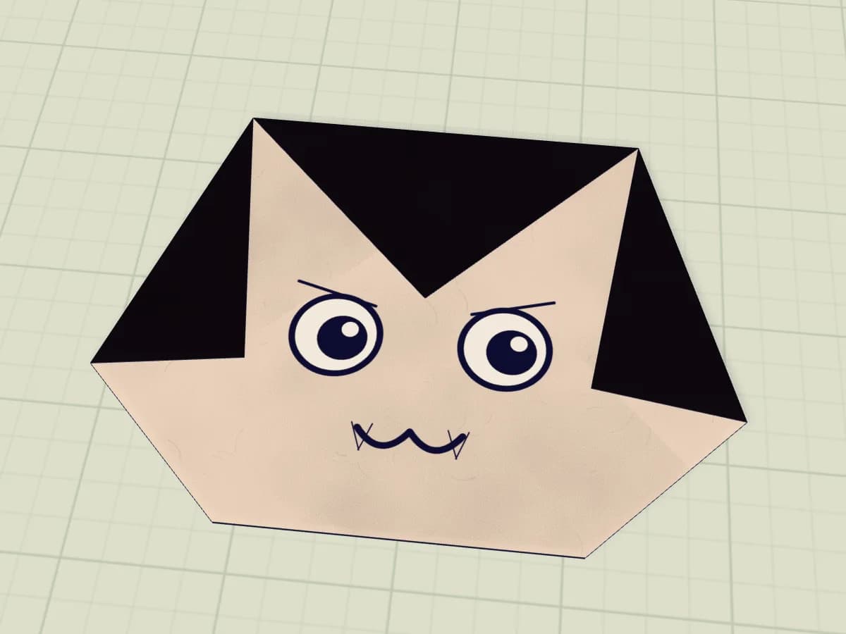 Tête de vampire en papier avec cheveux noirs et petites canines blanches